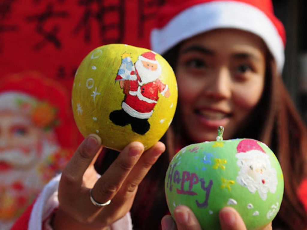 Vrouw met twee Chinese kerst appels